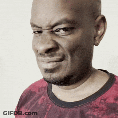 A Bald Man With A Beard Wearing A Red Shirt Makes A Funny Face GIF