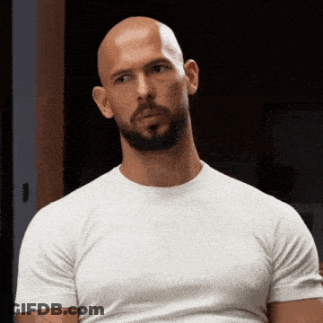 A Bald Man With A Beard Wearing A White T-Shirt GIF