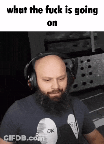 A Bald Man With A Beard Wearing Headphones And A Shirt That Says Ok On It GIF