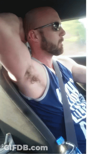 A Bald Man With A Beard Wearing Sunglasses And A Blue Tank Top That Says ' Chicago Bulls ' GIF