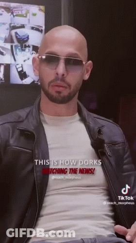 A Bald Man With A Beard Wearing Sunglasses And A Leather Jacket Says This Is How Dorks Watching The News GIF