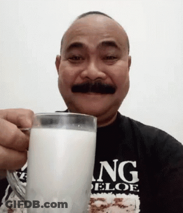 A Bald Man With A Mustache Is Holding A Glass Of Milk GIF