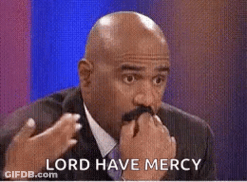 A Bald Man With A Mustache Is Holding His Hand To His Mouth While Talking . GIF
