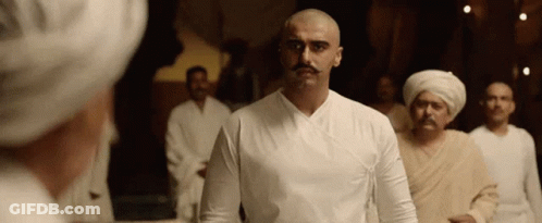 A Bald Man With A Mustache Is Standing In A Crowd Of Men GIF
