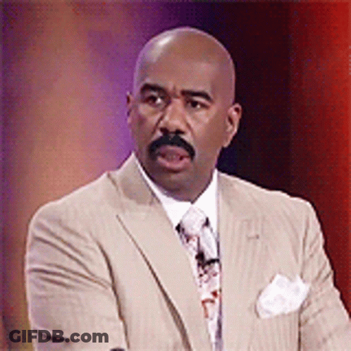 A Bald Man With A Mustache Wearing A Suit And Tie GIF