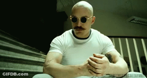 A Bald Man With A Mustache Wearing Sunglasses GIF