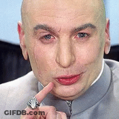 A Bald Man With A Ring On His Finger Is Making A Face GIF