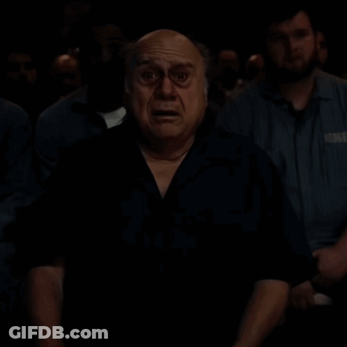 A Bald Man With A Surprised Look On His Face Is Looking At The Camera . GIF