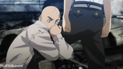 A Bald Man With A Tattoo On His Face Is Kneeling Down GIF