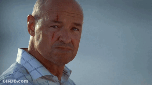 A Bald Man With Blood On His Face Is Smiling GIF