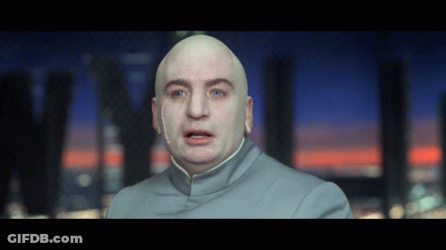 A Bald Man With Blue Eyes Is Wearing A Gray Shirt GIF