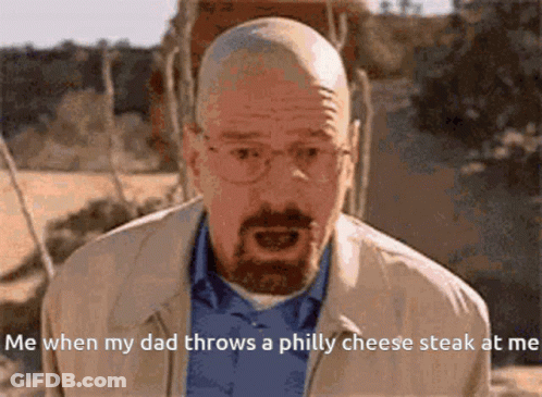 A Bald Man With Glasses And A Beard Is Talking About When His Dad Throws A Philly Cheese Steak At Him GIF