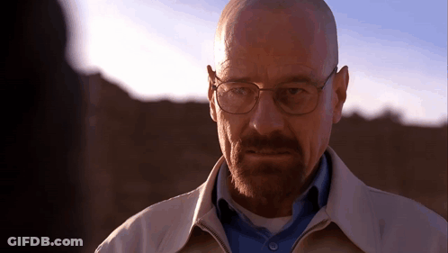 A Bald Man With Glasses And A Beard Looks At Someone GIF