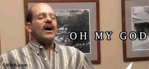 A Bald Man With Glasses And A Mustache Is Singing A Song In Front Of A Picture Of A Building . GIF