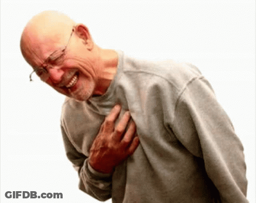 A Bald Man With Glasses Is Holding His Chest And Smiling GIF