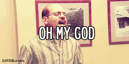 A Bald Man With Glasses Says Oh My God In Front Of Framed Pictures GIF