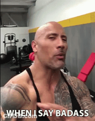 A Bald Man With Tattoos Is Talking In A Gym And Says " When I Say Badass " GIF