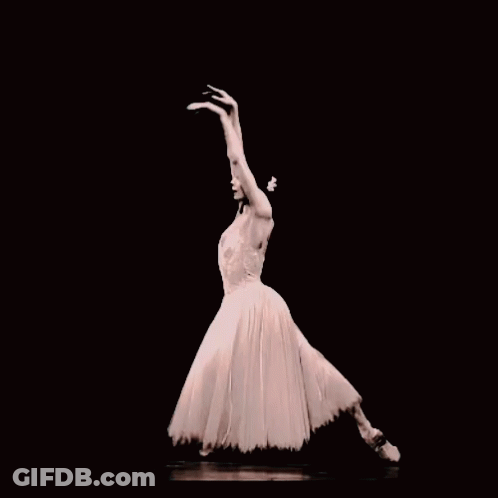 A Ballerina In A White Dress And Pointe Shoes Is Dancing In The Dark GIF