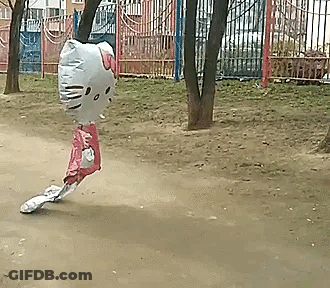 A Balloon In The Shape Of A Hello Kitty Is Flying Through The Air . GIF