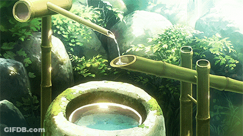A Bamboo Fountain Is Pouring Water Into A Bowl GIF