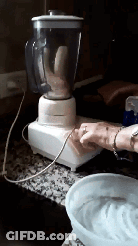 A Banana Is Being Blended In A Blender On A Counter Top GIF