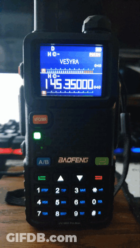 A Baofeng Radio Is Sitting On A Wooden Desk GIF