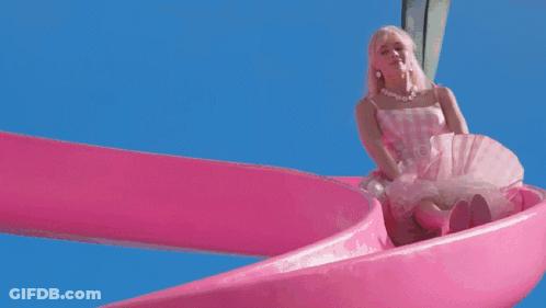 A Barbie Doll Is Going Down A Pink Water Slide In A Swimming Pool GIF