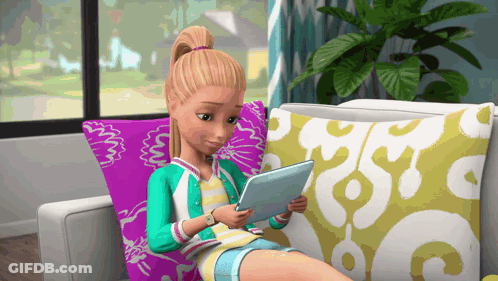 A Barbie Doll Is Sitting On A Couch Using A Tablet Computer GIF