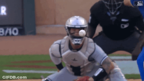 A Baseball Catcher Catches A Ball In Front Of A Scoreboard With The Number 8 10 On It GIF