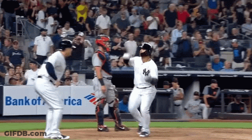 A Baseball Game Is Being Played In Front Of A Banner For Bank Of America GIF