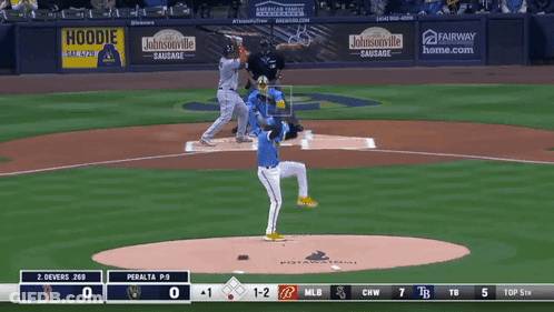 A Baseball Game Is Being Played In Front Of A Banner That Says Johnsonville Sausage GIF