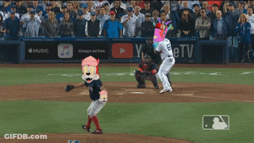 A Baseball Game Is Being Played In Front Of A Banner That Says Music GIF