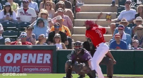A Baseball Game Is Being Played In Front Of A Bottle Opener Sign GIF
