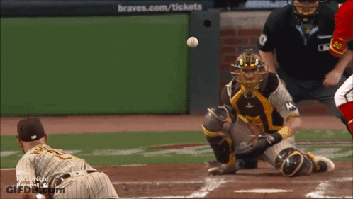 A Baseball Game Is Being Played In Front Of A Braves.com / Tickets Sign GIF