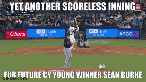 A Baseball Game Is Being Played In Front Of A Crowd And A Sign That Says Yet Another Scoreless Inning GIF