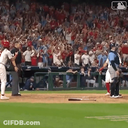 A Baseball Game Is Being Played In Front Of A Crowd With A Sign That Says Re/max On It GIF