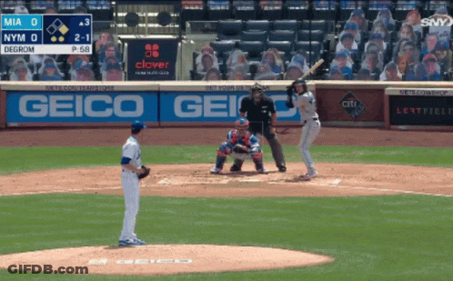 A Baseball Game Is Being Played In Front Of A Geico Ad GIF