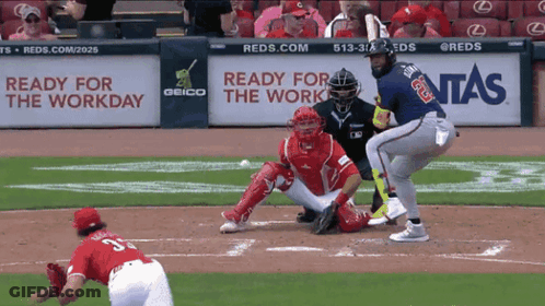 A Baseball Game Is Being Played In Front Of A Geico Sign GIF