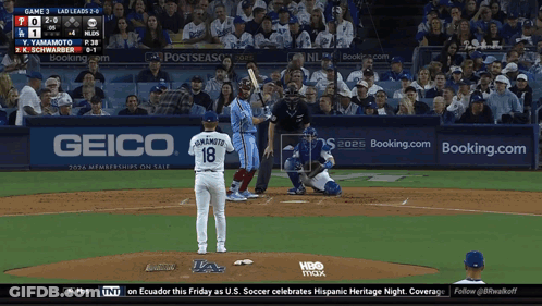 A Baseball Game Is Being Played In Front Of A Geico Sign GIF