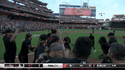 A Baseball Game Is Being Played In Front Of A Large Screen That Says Great American On It GIF