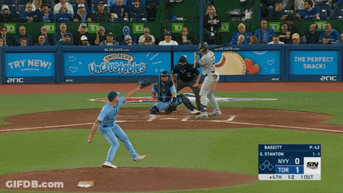 A Baseball Game Is Being Played In Front Of A Mucker 'S Uncrustables Banner GIF