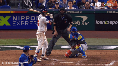 A Baseball Game Is Being Played In Front Of A Nippon Express Banner GIF