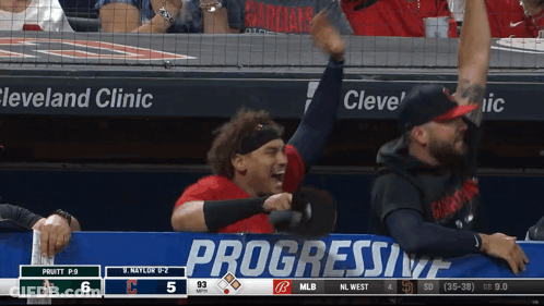 A Baseball Game Is Being Played In Front Of A Progressive Banner GIF