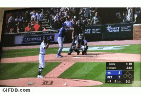 A Baseball Game Is Being Played In Front Of A Sign That Says Comienca Bank GIF