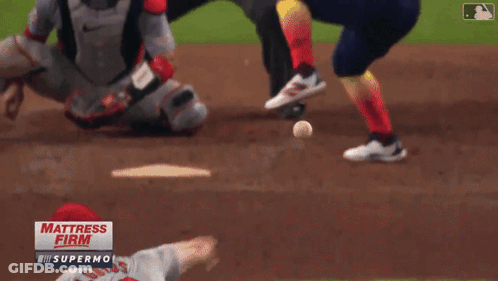 A Baseball Game Is Being Played In Front Of A Sign That Says " Mattress Firm " GIF