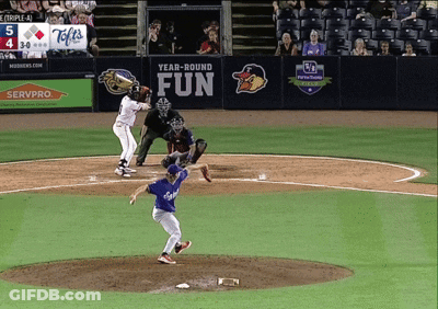 A Baseball Game Is Being Played In Front Of A Sign That Says " Year-Round Fun " GIF