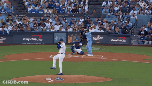 A Baseball Game Is Being Played In Front Of A Wall That Says Capital One On It GIF