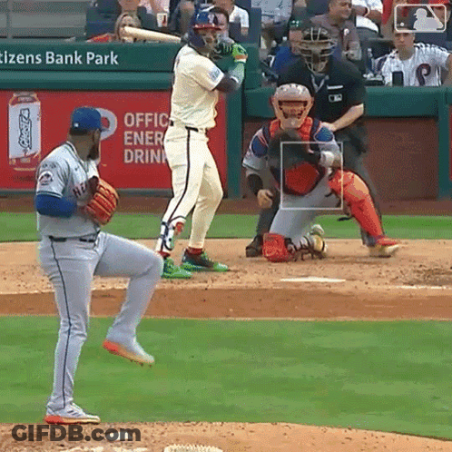A Baseball Game Is Being Played In Front Of An Ad For Coca Cola GIF