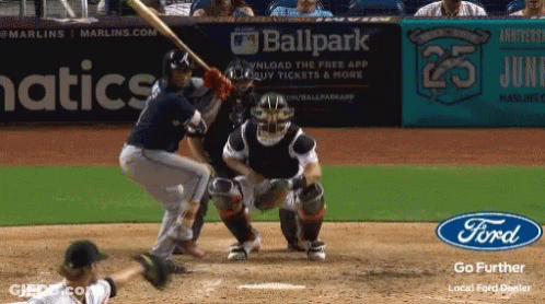 A Baseball Game Is Being Played In Front Of An Advertisement For Ballpark GIF