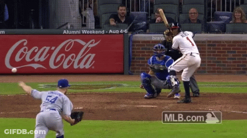 A Baseball Game Is Being Played In Front Of An Advertisement For Coca-Cola GIF